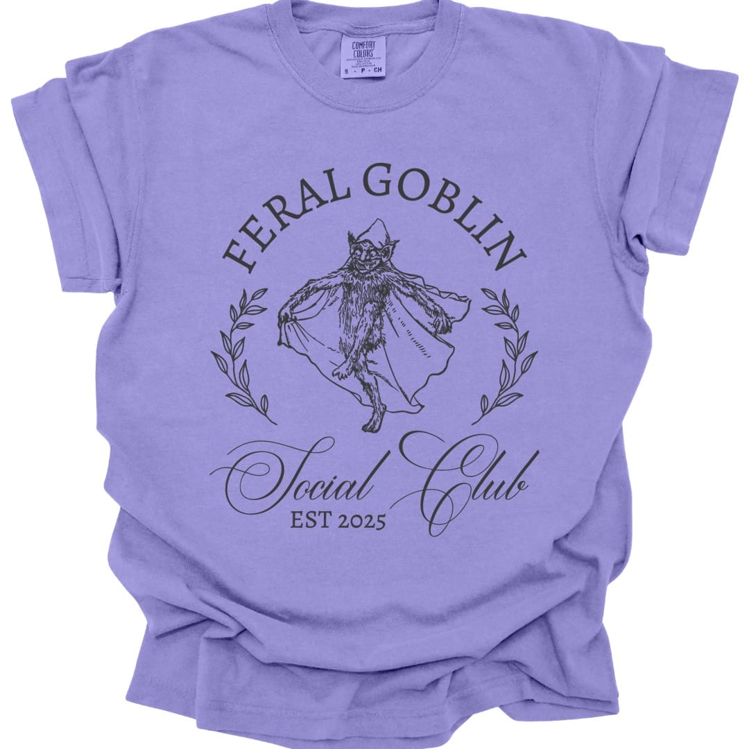 The same Feral Goblin Social Club, cat design, on a violet t-shirt.