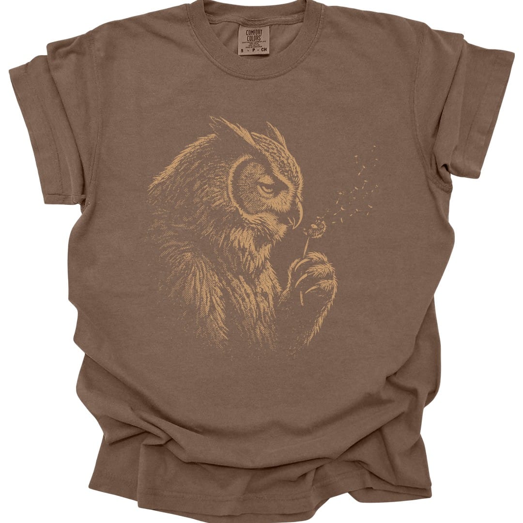 The same Owlbear Dandelion design, on an espresso t-shirt.