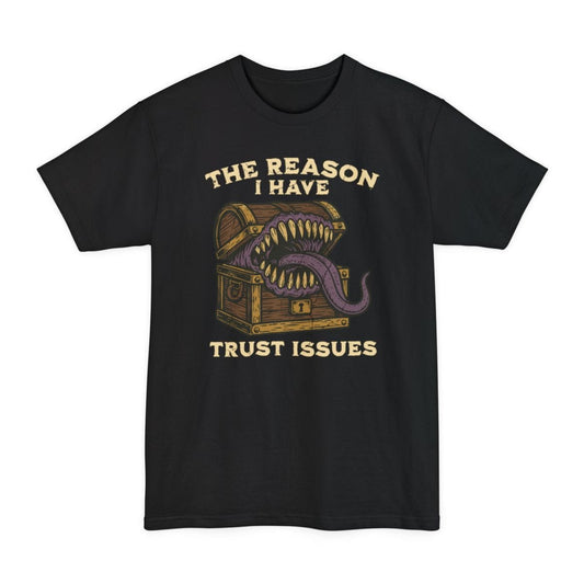 Black tall t-shirt. Reads "The reason I have" across the top and "Trust issues" across the bottom in cream capitals. Between them a wooden treasure chest gapes open as a mimic, lined with long yellow teeth and a purple tongue lolling out over the lid. Bold cartoon style in brown, gold and purple.