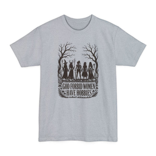 Light Steel tall t-shirt. The design reads "God Forbid Women Have Hobbies" in bold serif capitals across two lines at the bottom. Above the words five women adventurers stand in silhouette holding hands in a row, a wizard with a staff, a druid crowned with antlers, a knight in armor with a sword, a hooded ranger with daggers, and a sorcerer with an orb topped staff. Bare trees arch overhead and mushrooms and ferns crowd the ground. Cut paper silhouette art in one dark brown ink.