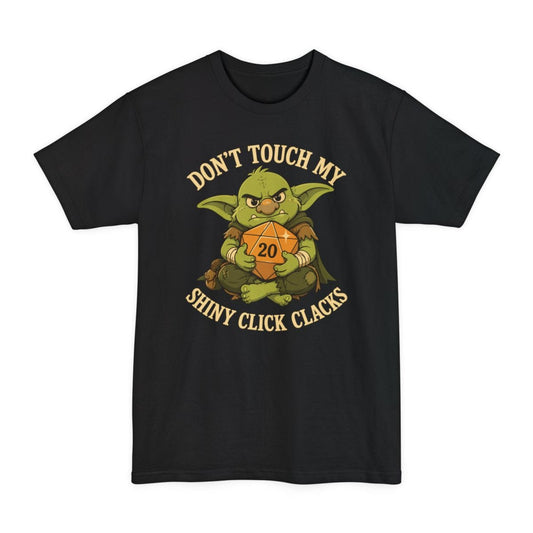 Black tall t-shirt. Reads "Don't touch my" curving across the top and "Shiny click clacks" across the bottom in cream capitals. Between them a green goblin sits scowling and hugging a large orange twenty-sided die showing 20 to its chest with both arms.
