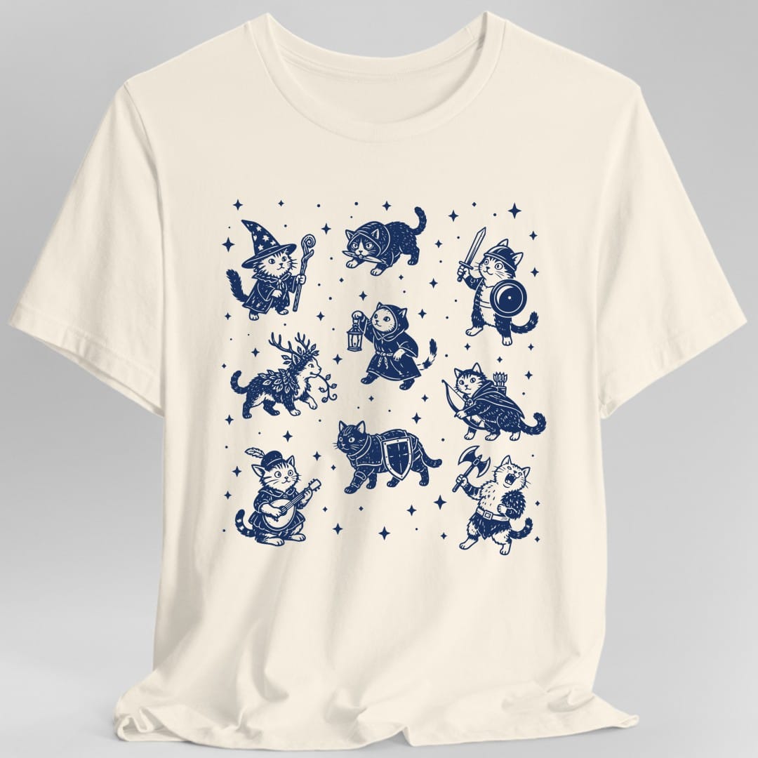 Natural t-shirt. No words. Nine cats dressed as fantasy adventurers are arranged in three rows among small four-pointed stars. Among them a wizard cat in a starry pointed hat with a staff, a cat in a hood carrying a lantern, a knight cat with a sword and round shield, an archer cat with a bow and quiver, a bard cat in a feathered cap playing a lute, an antlered cat trailing leafy vines, an armored cat with a shield, and a shaggy cat swinging an axe. Woodcut style line art in a single deep navy ink.