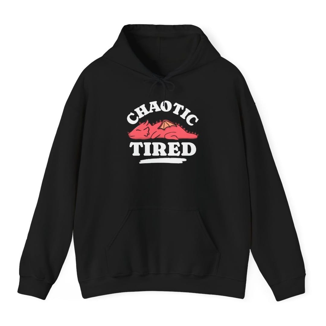 Black hoodie. Reads "Chaotic" curving across the top and "Tired" across the bottom in chunky white capitals. Between them a round pink dragon lies curled up fast asleep, eyes shut, wings folded, with a rough white brush stroke underneath it. Simple cartoon style in pink and white.