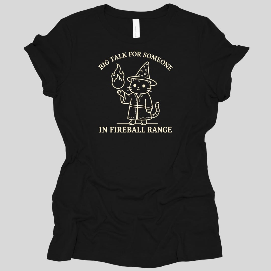 Black women's t-shirt. Reads "Big talk for someone" curving across the top and "In fireball range" across the bottom in cream capitals. Between them a cat stands upright in a starry pointed hat and robe, looking unimpressed, holding up a small flame in one paw.