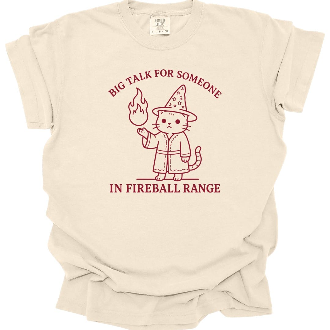 The same Big Talk for Someone in Fireball Range cat design, on an ivory t-shirt.