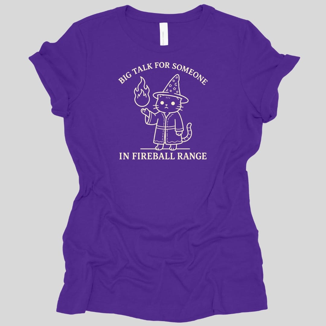 The same Big Talk for Someone in Fireball Range cat design, on a team purple women's t-shirt.