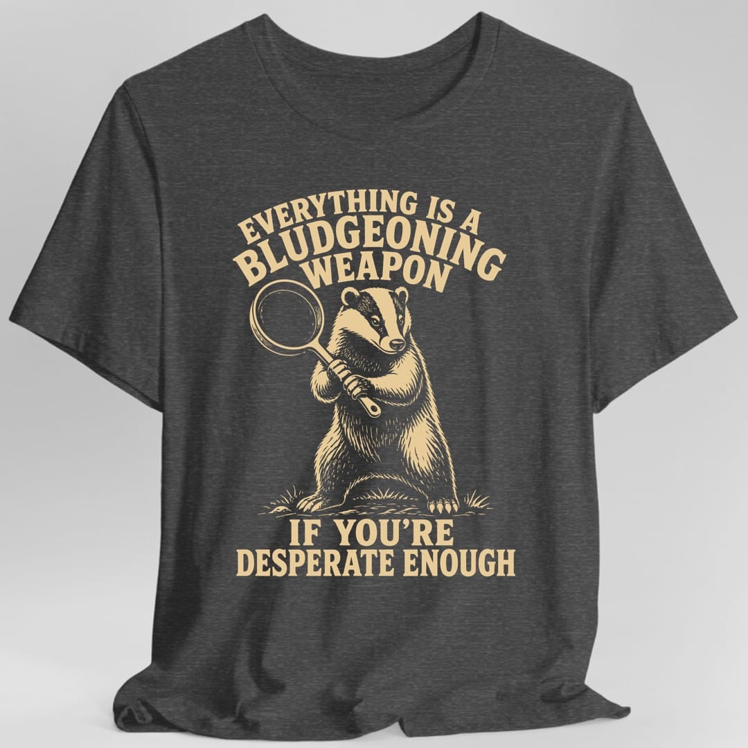 The same Bludgeoning Weapon badger design, on a dark heather t-shirt.