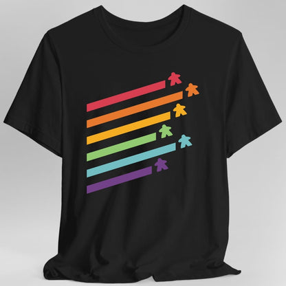 Black t-shirt. Five long diagonal stripes run across the design in rainbow colors, red, orange, green, blue and purple, each ending in a small meeple of the matching color. No words at all.
