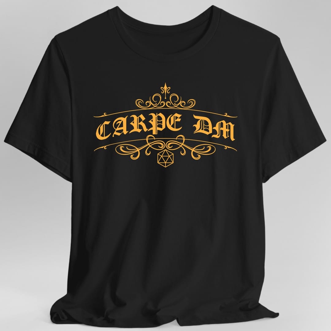 Black t-shirt. Reads "Carpe DM" in a large ornate serif with long curling flourishes sweeping out either side and above. A small twenty-sided die outline sits centered beneath the words. Fine decorative line work, all in a single warm gold.