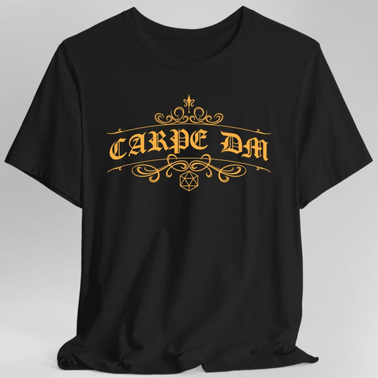 Black t-shirt. Reads "Carpe DM" in a large ornate serif with long curling flourishes sweeping out either side and above. A small twenty-sided die outline sits centered beneath the words. Fine decorative line work, all in a single warm gold.