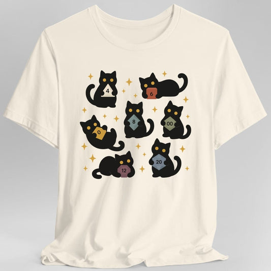 Natural t-shirt. Seven black cats with gold eyes sit and lie scattered across the design, each hugging a different polyhedral die to its chest. The dice are a cream four sided, a red six, a blue eight, a gold ten, a green percentile die marked double zero, a plum twelve and a steel blue twenty. Gold four pointed sparkles fill the gaps. Flat cartoon silhouettes, no words.