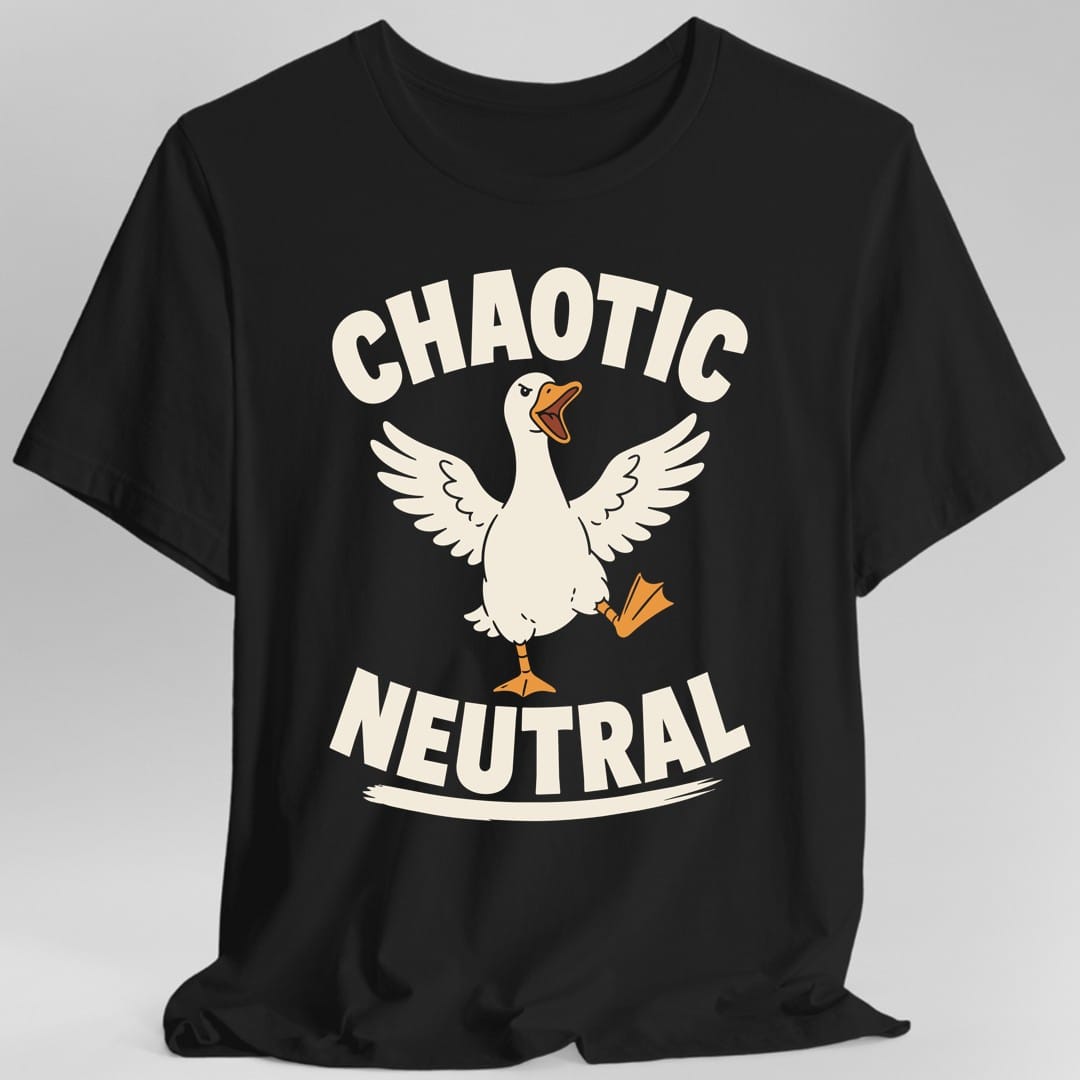 Black t-shirt. The design reads "CHAOTIC" above and "NEUTRAL" below, both in heavy cream letters curved around a cartoon goose. The goose stands mid-stride with its wings flung wide and its orange beak open mid-honk, one webbed foot kicked out behind it and its brow lowered in a glare. A short cream brush stroke sits under the lower word like a ground line.