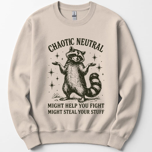 Sand sweatshirt. Reads "Chaotic Neutral" curving across the top in dark green capitals. Below, a raccoon stands upright with both paws spread in a shrug, drawn in fine engraving lines and ringed with sparkles. At the bottom, "Might help you fight, might steal your stuff." One dark green ink.