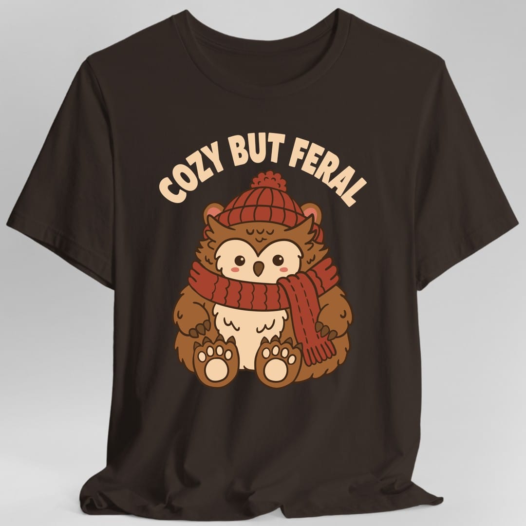 The same Cozy But Feral owlbear design, on a dark chocolate t-shirt.