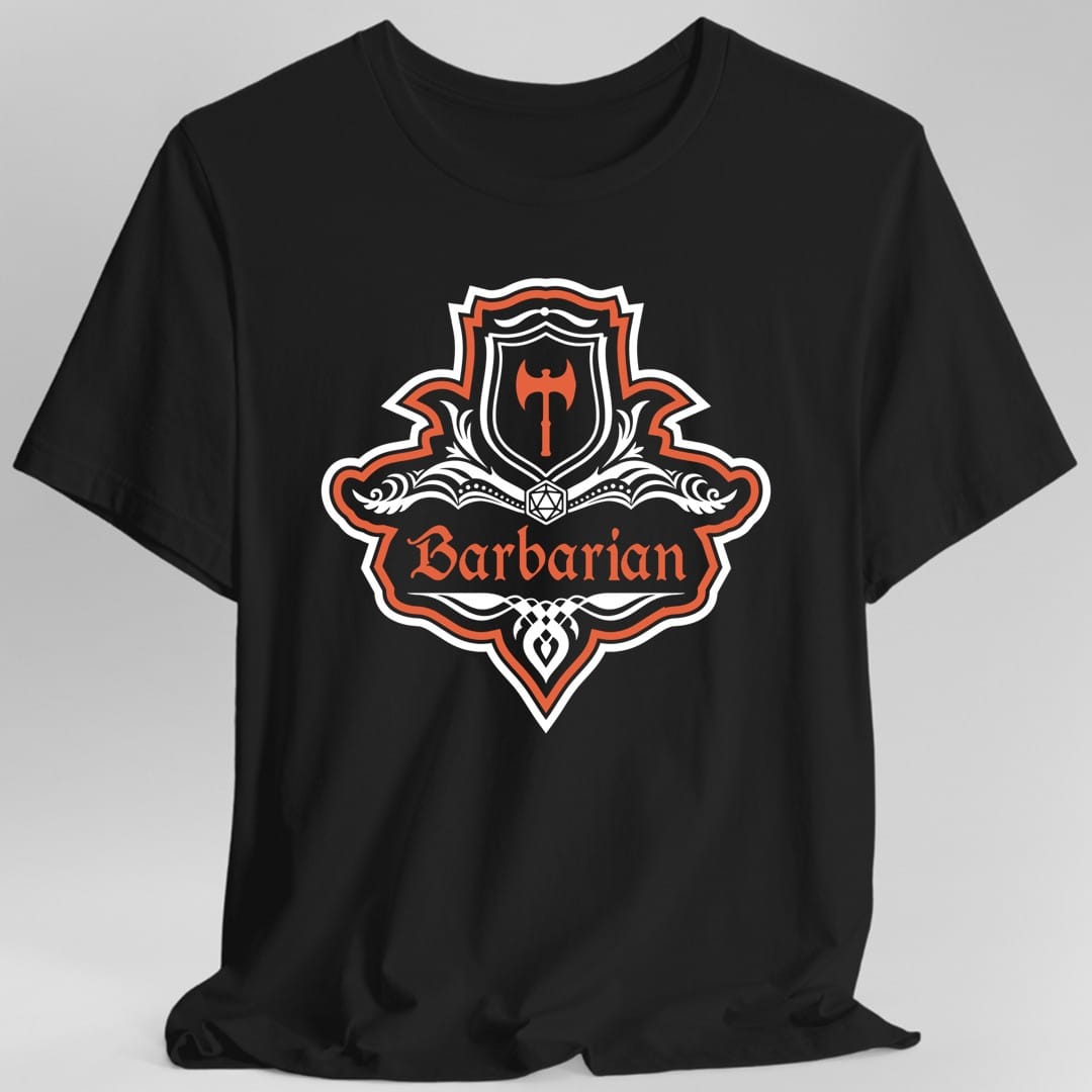 Black t-shirt. A crest shaped like a shield with scalloped edges, outlined in white and brick red. A small inner shield at the top carries a single broad axe, an open book with a twenty-sided die on it sits across the middle, and a banner below reads "Barbarian" in an ornate blackletter script. A pointed pendant hangs from the bottom. White line work with brick red accents.