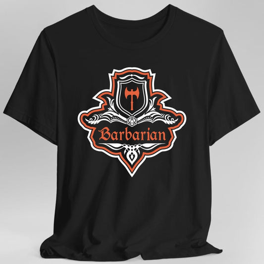 Black t-shirt. A crest shaped like a shield with scalloped edges, outlined in white and brick red. A small inner shield at the top carries a single broad axe, an open book with a twenty-sided die on it sits across the middle, and a banner below reads "Barbarian" in an ornate blackletter script. A pointed pendant hangs from the bottom. White line work with brick red accents.