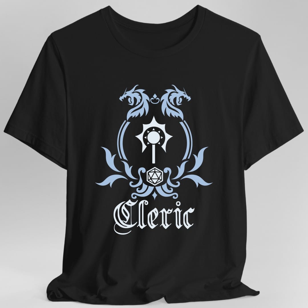 Black t-shirt. A heraldic crest drawn entirely in pale blue and white on a plain background. Two dragons face each other over an arched frame, a spiked mace sits inside the arch, and a twenty-sided die hangs below it between leafy flourishes. Underneath, "Cleric" in an ornate blackletter script.