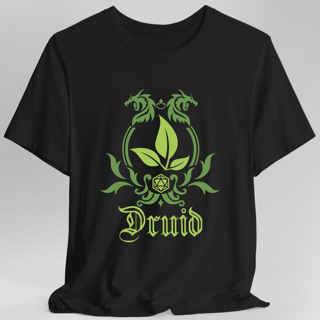 Black t-shirt. A heraldic crest drawn entirely in leaf green on a plain background. Curling vines arch over an arched frame, a sprig of three leaves sits inside it, and a twenty-sided die hangs below between leafy flourishes. Underneath, "Druid" in an ornate blackletter script.