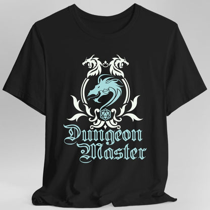Black t-shirt. A heraldic crest drawn entirely in white with a pale blue dragon on a plain background. Two dragons face each other over an arched frame, a coiled dragon sits inside it, and a twenty-sided die hangs below between leafy flourishes. Underneath, "Dungeon Master" in an ornate blackletter script.