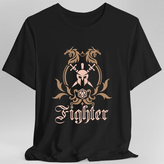 Black t-shirt. A heraldic crest drawn entirely in copper and tan on a plain background. Two dragons face each other over an arched frame, a helm behind crossed swords sits inside the arch, and a twenty-sided die hangs below it between leafy flourishes. Underneath, "Fighter" in an ornate blackletter script.