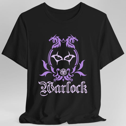 Black t-shirt. A heraldic crest drawn entirely in lavender and violet on a plain background. Two dragons face each other over an arched frame, a pair of watching eyes sits inside the arch, and a twenty-sided die hangs below it between leafy flourishes. Underneath, "Warlock" in an ornate blackletter script.