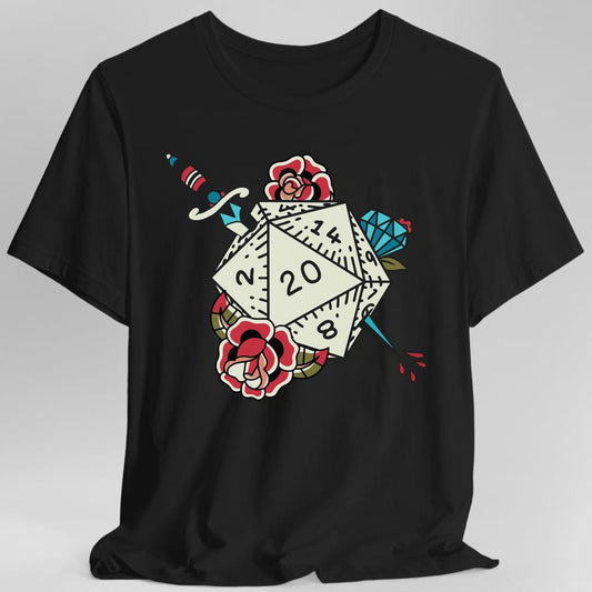 Black t-shirt. Drawn as an old-school tattoo: a cream twenty-sided die showing 20 sits in the middle with a dagger driven through it from the top and a blue crystal behind, with two red roses and green leaves either side and drops of blood falling.