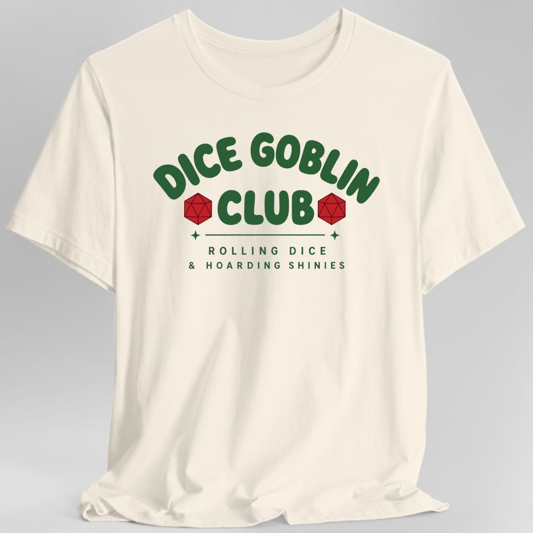 Natural t-shirt. The design reads Dice Goblin Club in bold rounded green capitals arched across the top, with a red twenty sided die sitting on either side of the word Club. Beneath a thin green rule flanked by two small green sparkles, a second line in spaced green capitals reads Rolling Dice and Hoarding Shinies. Flat collegiate style, all lettering and no illustration.