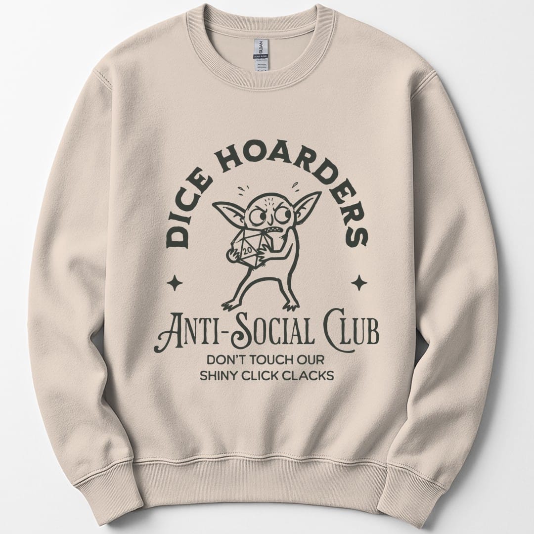 Sand sweatshirt. Reads "Dice hoarders" curving across the top and "Anti-social club" across the bottom in dark capitals, with "Don't touch our shiny click clacks" beneath. In the middle a goblin clutches a twenty-sided die to its chest, eyes wide, with a small star either side.
