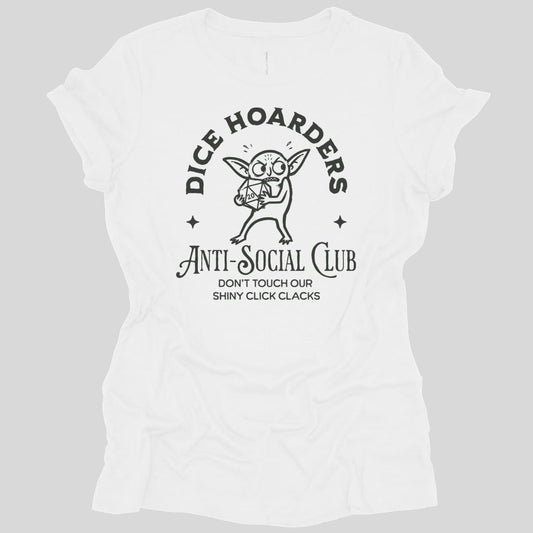 White women's t-shirt. Reads "Dice hoarders" curving across the top and "Anti-social club" across the bottom in dark capitals, with "Don't touch our shiny click clacks" beneath. In the middle a goblin clutches a twenty-sided die to its chest, eyes wide, with a small star either side.