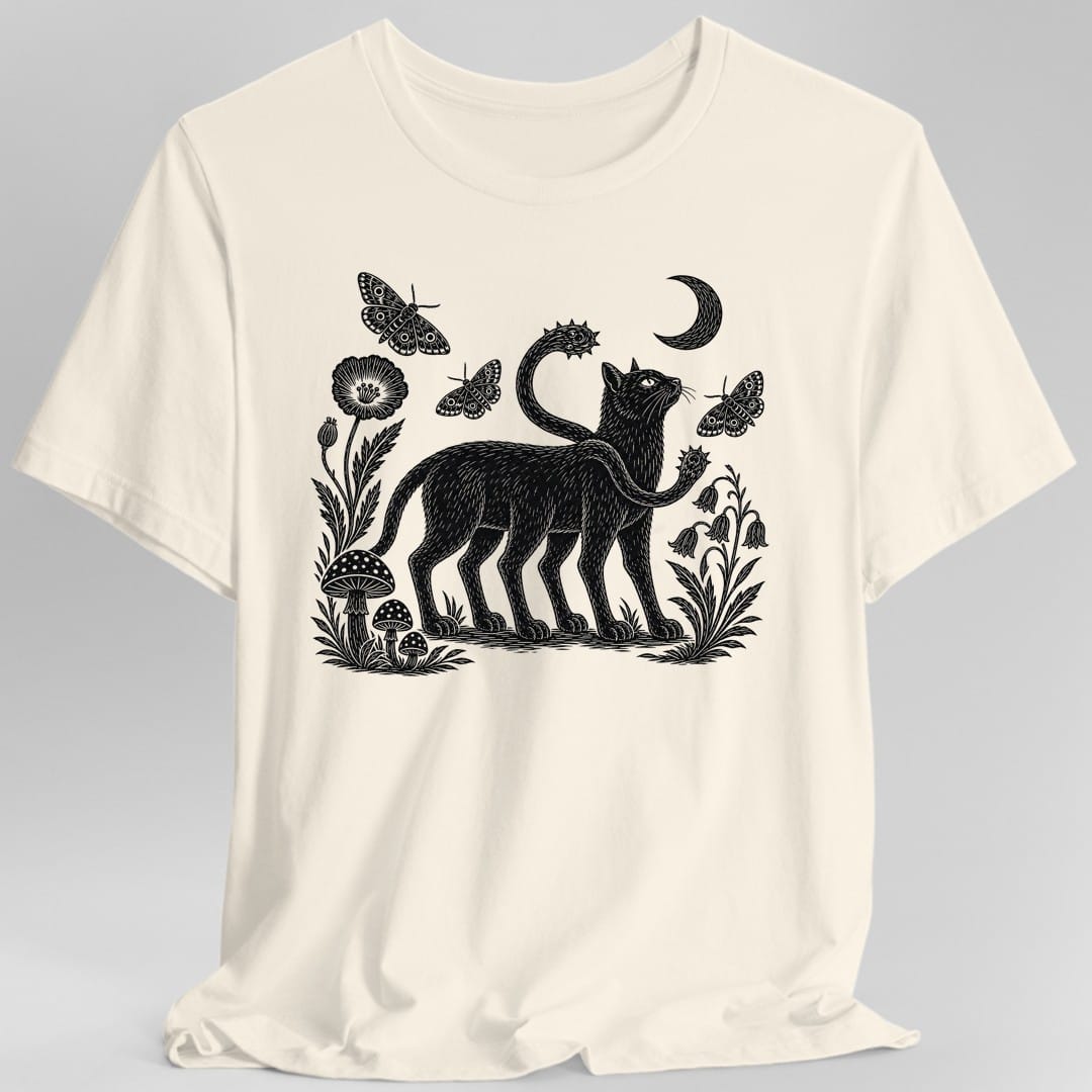 Natural t-shirt. No words. A black cat-like displacer beast stands in profile looking up at a crescent moon, with two spiked tentacles curving from its shoulders. Around it are spotted mushrooms, a tall poppy, bluebells and grasses, and three patterned moths in the air. Dense woodcut engraving style, printed in a single black ink.
