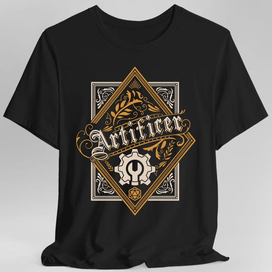 Black t-shirt. A tall gold diamond crest inside a decorative border, with "Artificer" written across the middle in an ornate blackletter. Below the word sits a cogwheel with a wrench through it, and a small twenty-sided die sits at the bottom point. Fine gold and cream line work.