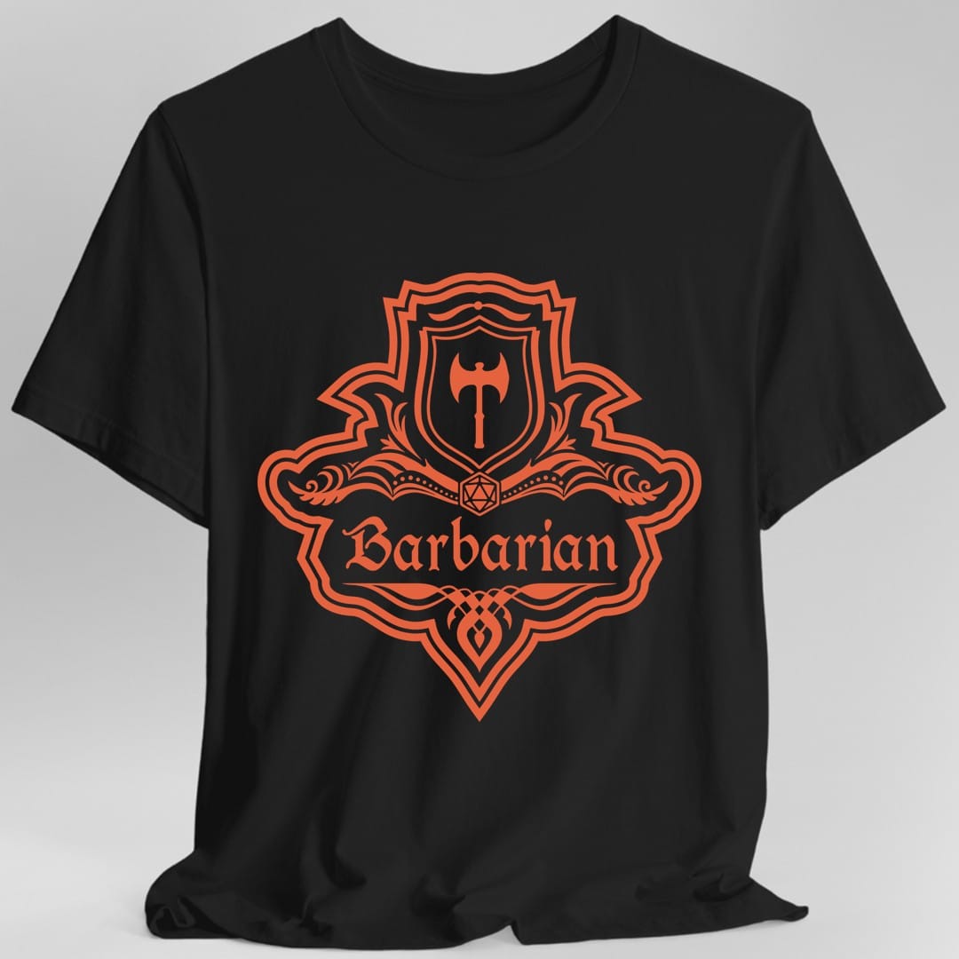 Black t-shirt. A crest shaped like a shield with scalloped edges, drawn entirely in burnt orange with no other color. A small inner shield at the top carries a single broad axe, an open book with a twenty-sided die on it sits across the middle, and a banner below reads "Barbarian" in an ornate blackletter script. A pointed pendant hangs from the bottom.