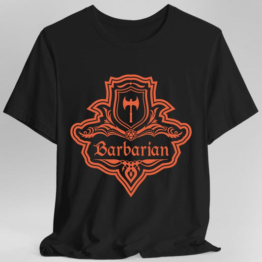 Black t-shirt. A crest shaped like a shield with scalloped edges, drawn entirely in burnt orange with no other colour. A small inner shield at the top carries a single broad axe, an open book with a twenty-sided die on it sits across the middle, and a banner below reads "Barbarian" in an ornate blackletter script. A pointed pendant hangs from the bottom.