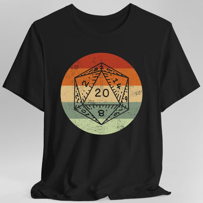 Black t-shirt. A twenty-sided die outline sits inside a circle divided into three broad horizontal bands, dark red at the top, cream in the middle and sage green at the bottom. The die shows 20. Distressed retro texture throughout. No words.