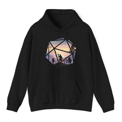 Black hoodie. A large twenty-sided die shape whose triangular facets act as windows onto one continuous landscape. Inside, a party of hooded adventurers in silhouette walks a rocky ridge toward misty violet mountains and a pale gold sunset, a bare tree on the left and pines on the right. The lead figure carries a tall axe. Soft flat illustration in lilac, dusty pink, cream and near black. No words.