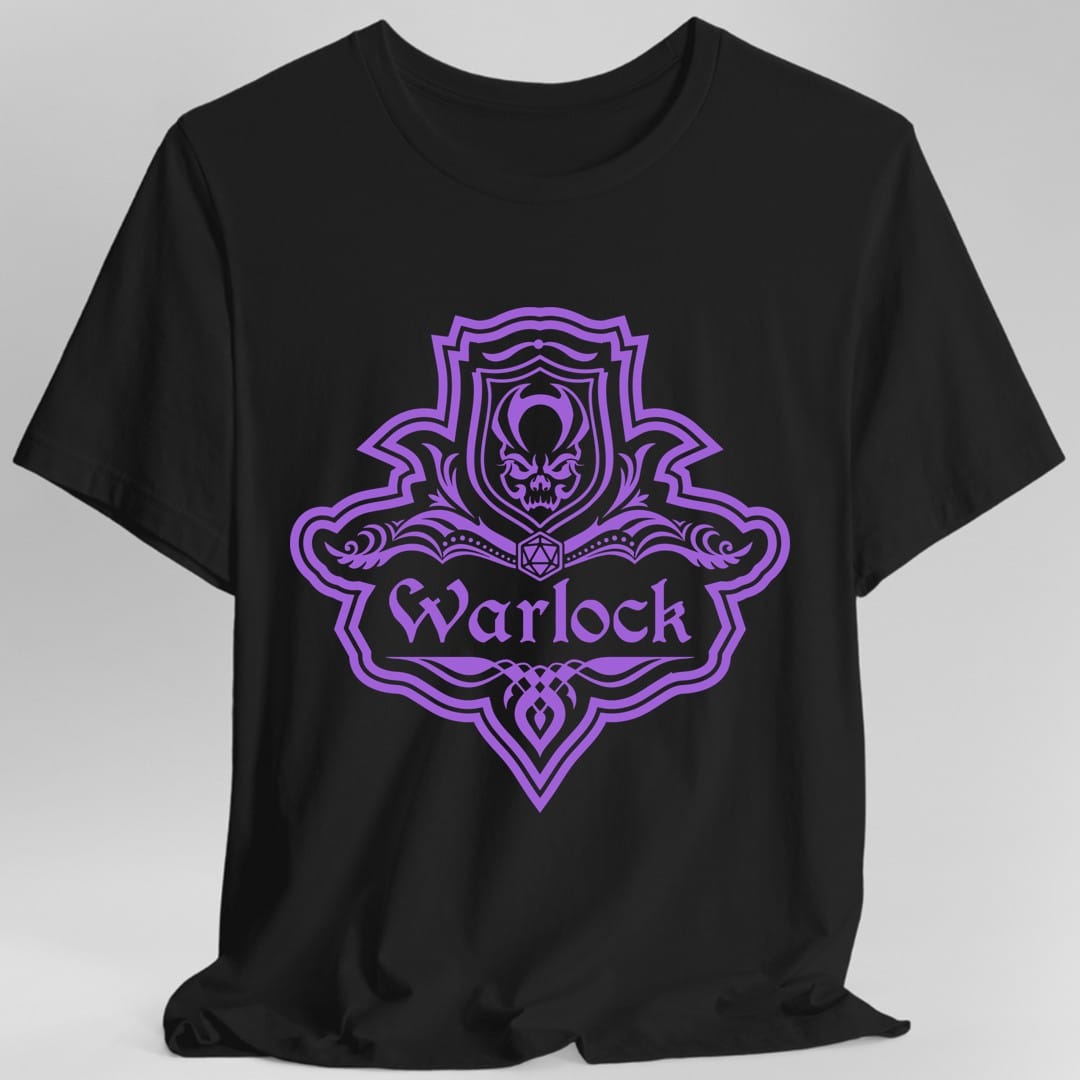Black t-shirt. A crest shaped like a shield with scalloped edges, drawn entirely in violet with no other color. A small inner shield at the top carries a tentacled shape, an open book with a twenty-sided die on it sits across the middle, and a banner below reads "Warlock" in an ornate blackletter script. A pointed pendant hangs from the bottom.