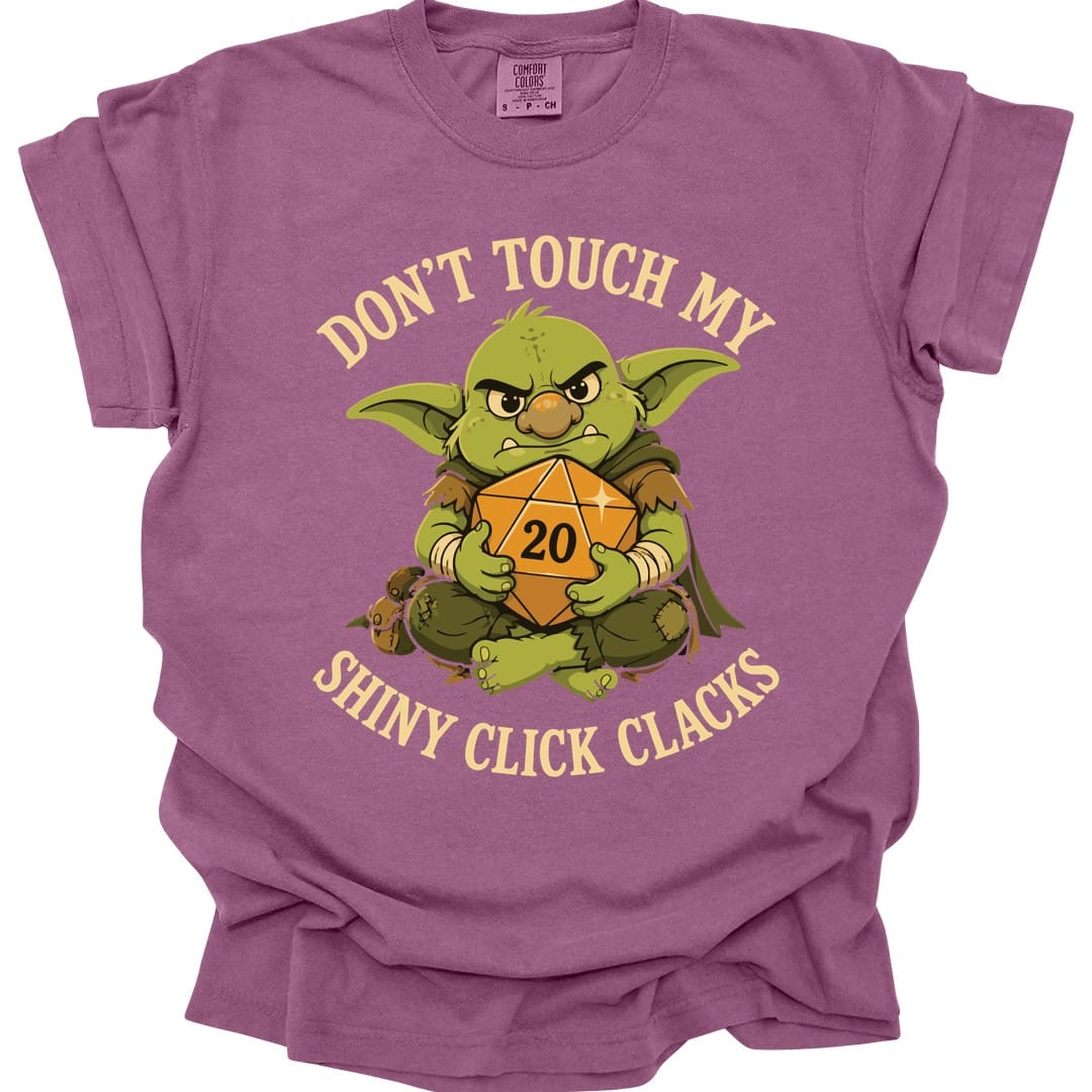 The same Don't Touch My Shiny Click Clacks design, on a berry t-shirt.