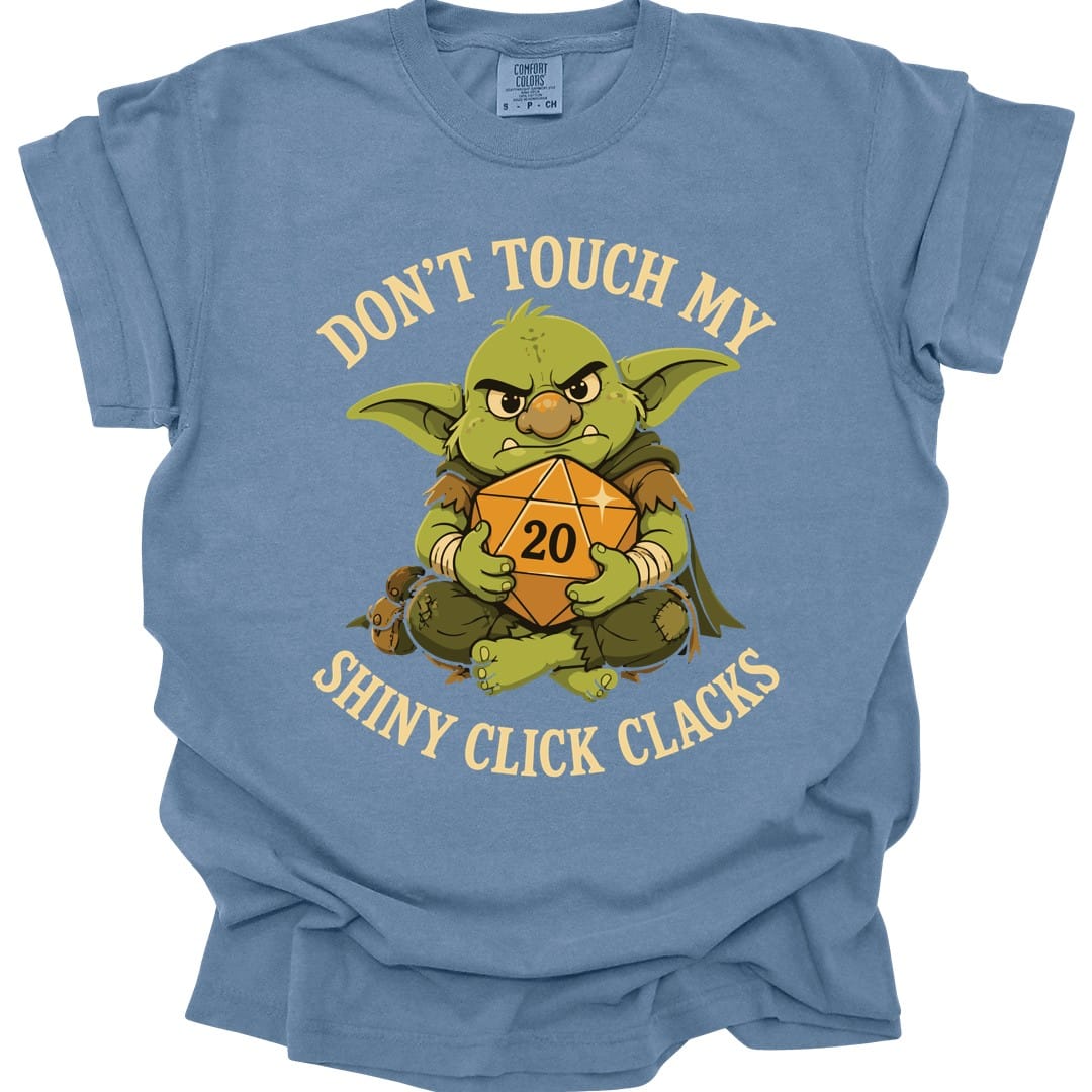 The same Don't Touch My Shiny Click Clacks design, on a blue jean t-shirt.