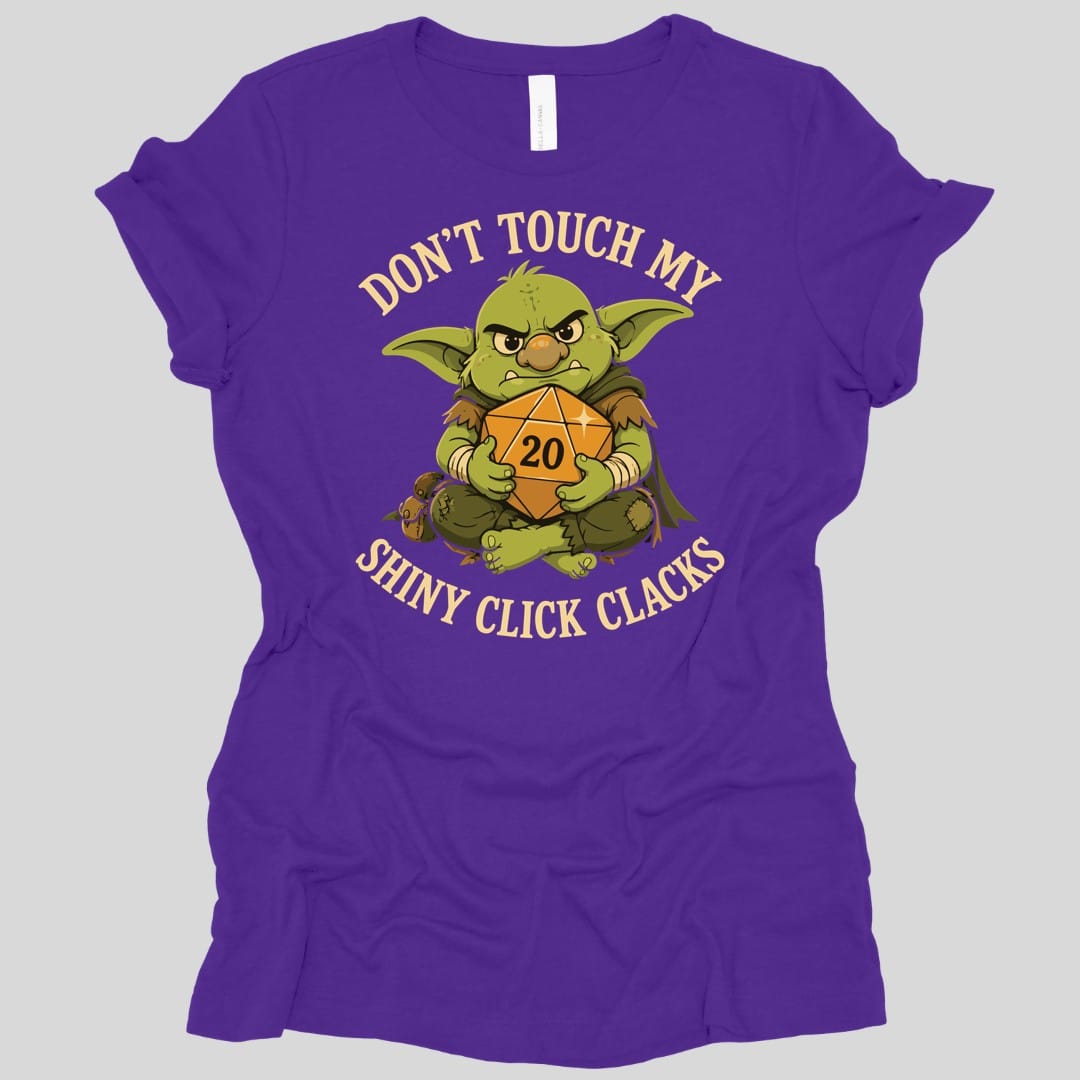 The same Don't Touch My Shiny Click Clacks design, on a team purple women's t-shirt.