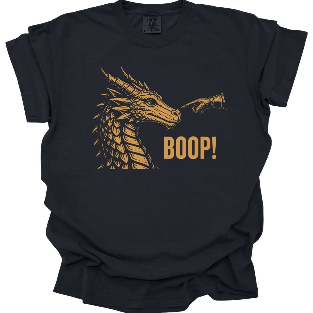 Black t-shirt. A gold dragon head in profile faces right with its horns swept back and jaws closed, drawn in fine engraved lines. A hand reaches in from the right and presses a finger to the tip of its snout. Beneath, "Boop!" in gold capitals.