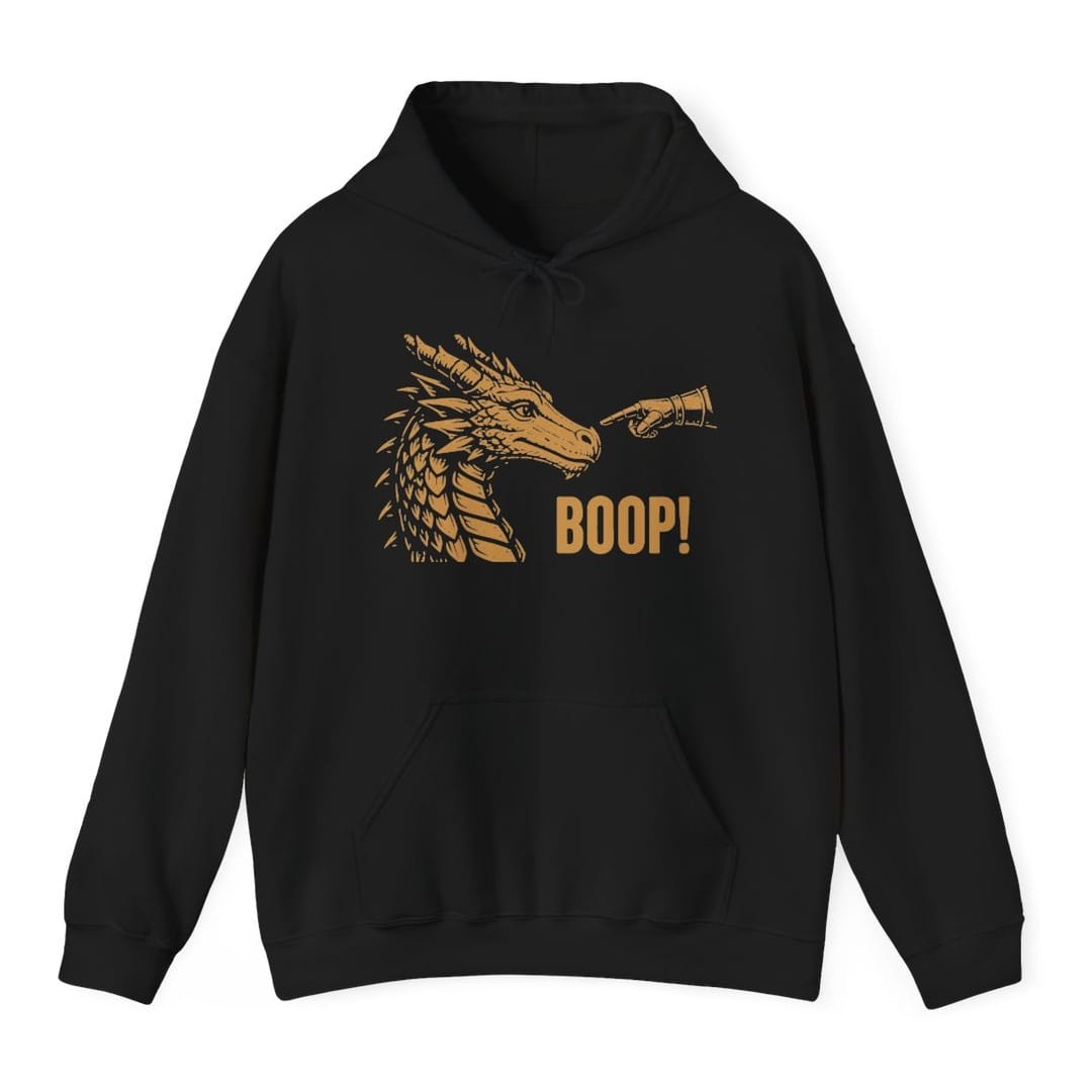 Black hoodie. A gold dragon head in profile faces right with its horns swept back and jaws closed, drawn in fine engraved lines. A hand reaches in from the right and presses a finger to the tip of its snout. Beneath, "Boop!" in gold capitals.
