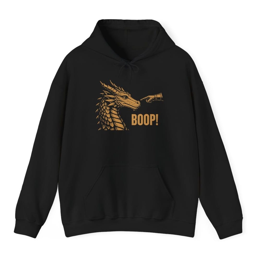 Black hoodie. A dragon head in profile faces right with its horns swept back and jaws closed, drawn in fine engraved lines. A hand in an armored gauntlet reaches in from the right and presses one finger to the tip of its snout, and "Boop!" sits below in bold capitals. Gold on dark colors, dark brown on light ones.