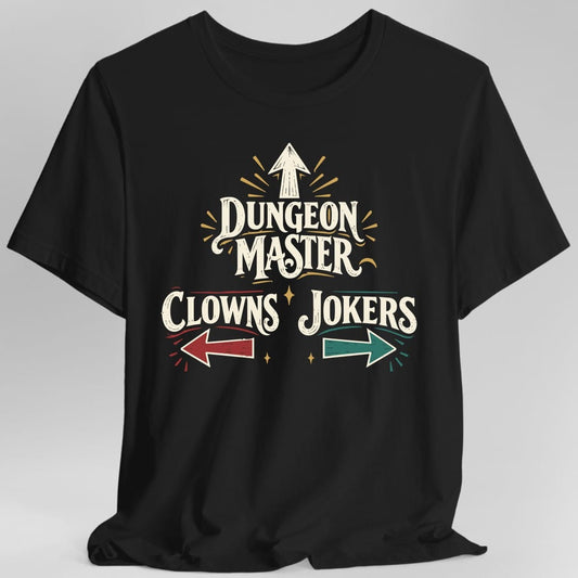 Black t-shirt. The design reads "Dungeon Master" in large vintage circus lettering, with an arrow pointing straight up above it. Below, "Clowns" sits on the left with a red arrow pointing left, and "Jokers" on the right with a teal arrow pointing right. Small gold sparkles and radiating lines surround the words. Cream lettering with red, teal and gold accents in a retro sign style.