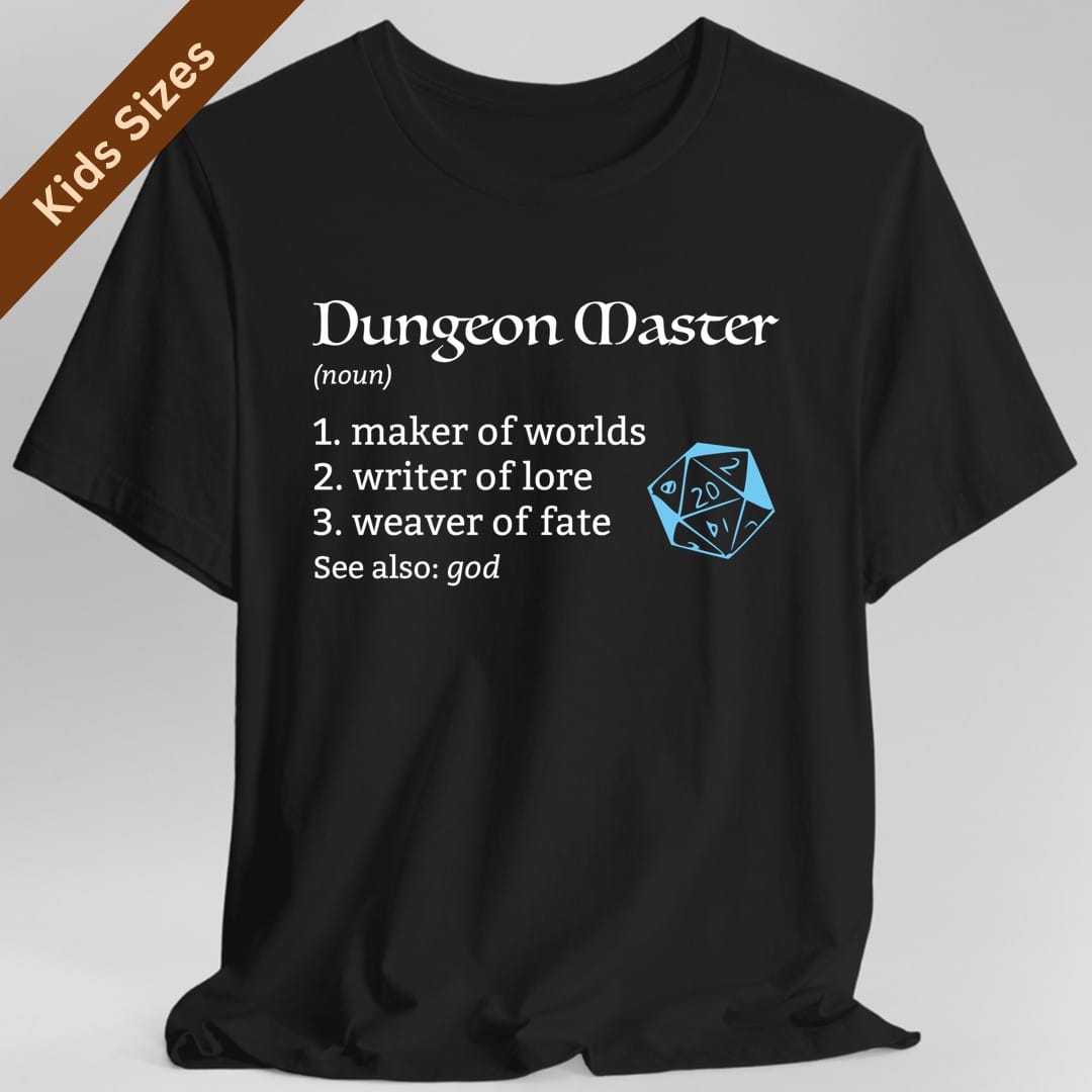 Black kids t-shirt. Set out like a dictionary entry. "Dungeon Master" heads it in a white medieval serif with "(noun)" beneath, then a numbered list reading "1. maker of worlds, 2. writer of lore, 3. weaver of fate", and a last line reading "See also: god". A sky-blue outlined twenty-sided die showing 20 floats to the right of the list. Mostly type, white with one blue accent.