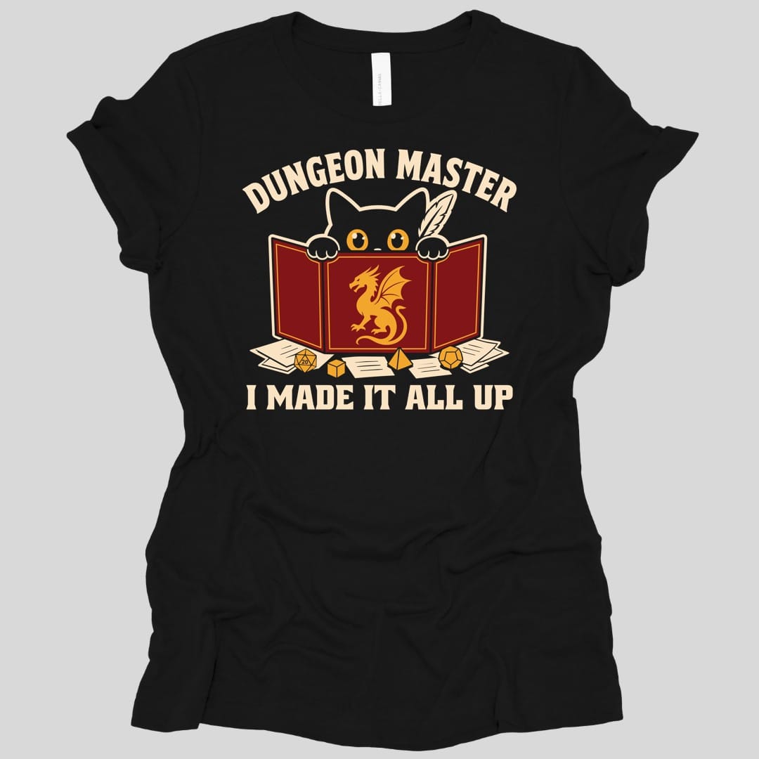 Black women's t-shirt. Reads "Dungeon Master" curving across the top in cream capitals. Below, a white cat peers over the top of a dark red dungeon master screen with a gold dragon printed on it, paws hooked over the edge, papers and dice scattered around. Across the bottom, "I made it all up".