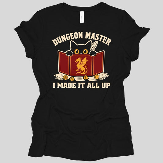 Black women's t-shirt. Reads "Dungeon Master" curving across the top in cream capitals. Below, a white cat peers over the top of a dark red dungeon master screen with a gold dragon printed on it, paws hooked over the edge, papers and dice scattered around. Across the bottom, "I made it all up".
