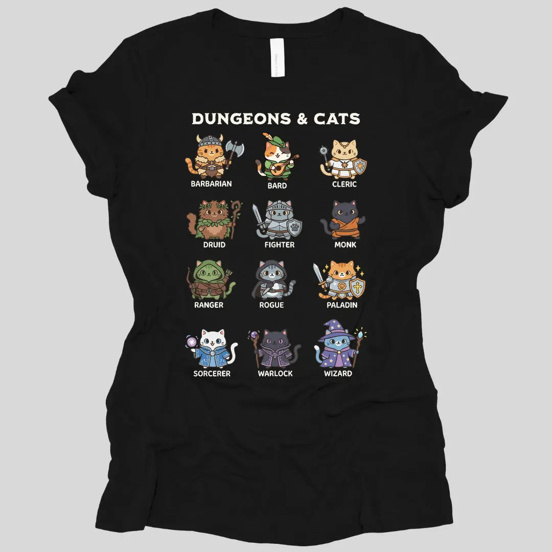 Black women's t-shirt. Reads "Dungeons and Cats" in chunky lettering across the top, cream on dark colors and dark gray on light ones. Below it twelve round cartoon cats stand in a grid, each dressed as a Dungeons and Dragons class and labeled underneath: a barbarian in a horned helmet with an axe, a bard with a lute, a cleric, a druid, a fighter, a monk, a ranger, a rogue, a paladin, a sorcerer, a warlock and a wizard. Soft kawaii illustration.