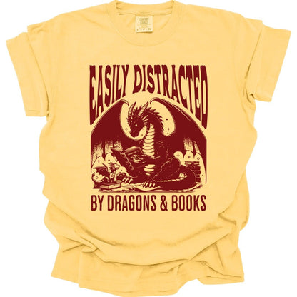 The same Easily Distracted by Dragons and Books design, on a butter t-shirt.