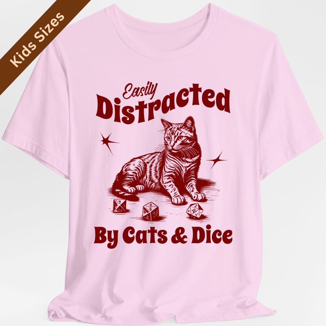 The same Easily Distracted By Cats and Dice design, on a light pink kids t-shirt.