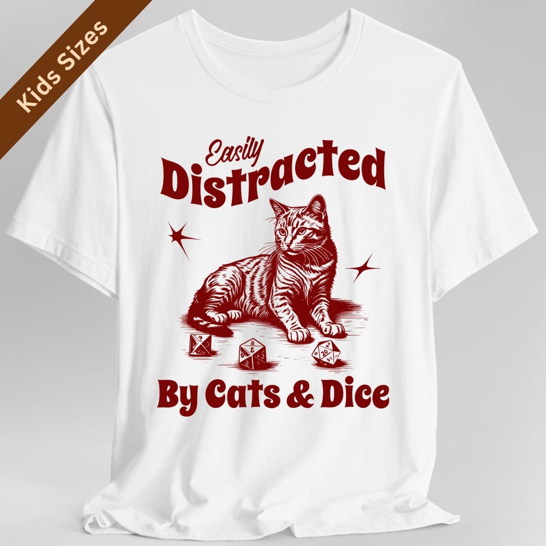 White kids t-shirt. Reads "Easily Distracted" across the top, Easily in a slanted script and Distracted in fat retro capitals, and "By Cats and Dice" across the bottom in the same fat style. Between them a striped tabby cat sits upright with its tail curled and three polyhedral dice scattered by its paws, a starburst either side. Vintage engraved linework in a single deep crimson.
